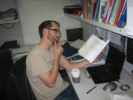 Ciaran in his smarty-pants PhD office, doing smart things.